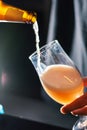 Bartender pouring craft beer in to the glass