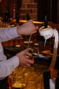 Bartender pouring draft beer from the crane into the glass in pub Royalty Free Stock Photo