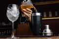 a bartender pouring a drink with a martini at a bar Royalty Free Stock Photo