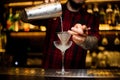 Bartender pouring fresh alcoholic drink into an elegant glass Royalty Free Stock Photo