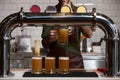 Bartender pouring fresh beer into the beer glass at bar counter, close-up Royalty Free Stock Photo