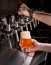 Bartender pouring fresh beer into glass in pub Royalty Free Stock Photo