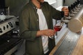 Bartender pouring fresh beer into glass in pub Royalty Free Stock Photo