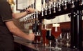 Bartender pouring fresh beer into glass in pub, closeup Royalty Free Stock Photo