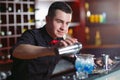 Bartender pouring fresh cocktail in fancy glass. Royalty Free Stock Photo