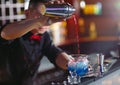 Bartender pouring fresh cocktail in fancy glass. Royalty Free Stock Photo