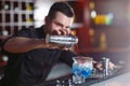 Bartender pouring fresh cocktail in fancy glass. Royalty Free Stock Photo