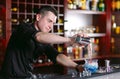 Bartender pouring fresh cocktail in fancy glass. Royalty Free Stock Photo