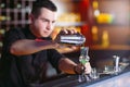 Bartender pouring fresh cocktail in fancy glass Royalty Free Stock Photo