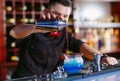 Bartender pouring fresh cocktail in fancy glass. Royalty Free Stock Photo