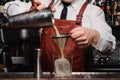 Bartender pouring fresh cocktail in fancy glass Royalty Free Stock Photo