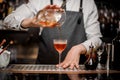 Bartender pouring fresh sweet alcoholic drink into the cocktail glass Royalty Free Stock Photo