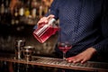 Bartender pouring fresh and sweet pink summer cocktail into the glass Royalty Free Stock Photo