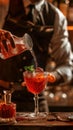 Bartender Pouring a Garnished Cocktail at an Ambient Bar During Evening Hours