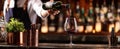 The bartender pouring a glass of red wine in a dimly lit bar setting. AI generated image Royalty Free Stock Photo