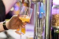Bartender pouring lager beer in a glass. Shallow dof, selective focus. Royalty Free Stock Photo
