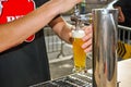 Bartender pouring light beer from the crane.