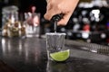 Bartender pouring Mexican Tequila into glass at bar counter, closeup Royalty Free Stock Photo