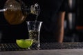 Bartender pouring Mexican Tequila into shot glass on bar counter. Space for text Royalty Free Stock Photo