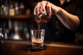 A bartender pouring a perfectly measured shot of liquor into a mixing glass, demonstrating precision and expertise in cocktail