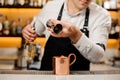 Bartender pouring a portion of alcoholic drink into a cup Royalty Free Stock Photo
