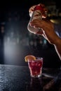 Bartender pouring powder on Sweet juicy Cocktail drink on a bar counter. Bartender view. Copy paste for design people