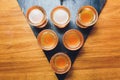 Bartender pouring strong alcoholic drink into small glasses on bar, shots. Royalty Free Stock Photo