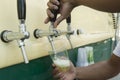 Bartender pouring from tap fresh beer into the plastic cup Royalty Free Stock Photo