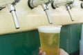 Bartender pouring from tap fresh beer into the plastic cup Royalty Free Stock Photo