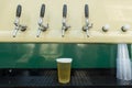 Bartender pouring from tap fresh beer into the plastic cup Royalty Free Stock Photo