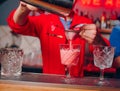 Bartender pouring using strainer Sweet pink healthy Cocktail drink on a bar counter . Bartender view . Trendy stylish white. CopyB Royalty Free Stock Photo