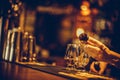 Bartender pouring whisky in a glass Royalty Free Stock Photo