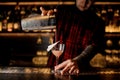 Bartender pourring an alcohol making cocktail in the glass