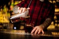 Bartender pourring a Hamm`s Delight cocktail from the measuring