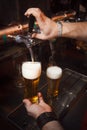 The bartender pours a beer in glass Royalty Free Stock Photo