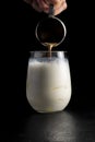 The bartender pours coffee into ice latte milk froth. Cold coffee drink cocktail made of milk, coffee and ice Royalty Free Stock Photo