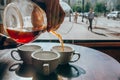 Bartender pours coffee to cups Royalty Free Stock Photo