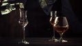 The bartender pours the vodka or grappa in small shot glass on the old bar counter. Vintage wooden background in pub or bar, night Royalty Free Stock Photo