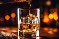 The bartender pours whiskey into a glass with ice on the bar counter. close-up. Blurred background. Elite alcoholic drink Royalty Free Stock Photo