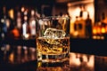 The bartender pours whiskey into a glass with ice on the bar counter. close-up. Blurred background. Elite alcoholic drink Royalty Free Stock Photo