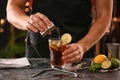 Barman making Cuba Libre cocktail with lime and ice Royalty Free Stock Photo