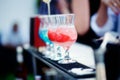 Bartender preparing a cocktail with blue and red syrup Royalty Free Stock Photo