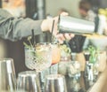 Bartender preparing cocktails for on cruise american bar - Barman at work mixing and using shaker - Focus on rosemary - Travel , Royalty Free Stock Photo