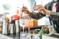 Bartender preparing different cocktails mixing with straws inside bar - Profession, work and lifestyle concept Royalty Free Stock Photo