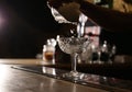 Bartender preparing alcoholic cocktail at bar counter, closeup Royalty Free Stock Photo