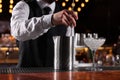 Bartender preparing fresh alcoholic cocktail at bar counter, closeup Royalty Free Stock Photo