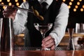 Bartender preparing fresh Martini cocktail at bar counter, closeup Royalty Free Stock Photo