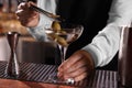 Bartender preparing fresh Martini cocktail at bar counter, closeup Royalty Free Stock Photo