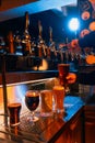 Bartender's hand filling tall glass with dark beer beside selection of other beer styles. Serving craft beer from Royalty Free Stock Photo