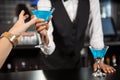 Bartender serving blue cocktail at bar counter Royalty Free Stock Photo
